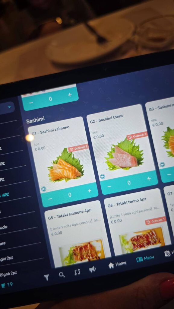 Kan een afbeelding zijn van telefoon en de tekst '0 G3- Sashimi Sashimi G1-Sashimisalmone G1 Sashimi salmone G2-Sashimitonno G2 Sashimi tonno 6pz €0.00 4pz 0.00 4px €0.00 00 €0 و Ordered: 5 PZ ف Ordorad: PZ 4PZ C 0 0 G7 ccio G5 Tataki salmone 4pz G6- Tataki tonno 4pz [Limite volta ogni personal To... €0.00 1p e (Limite volta ogni personaj Sa. €0.00 are 9 Ordered:1 giri 2pz Bigne ignè2pz 2pz 明 Menu 家 Home'